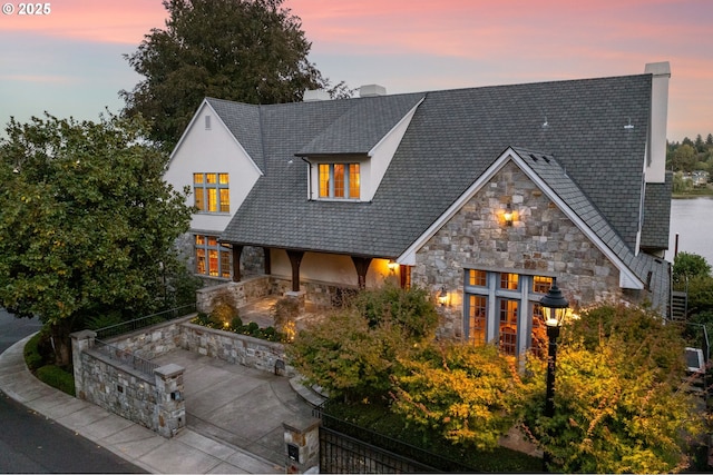 view of back house at dusk