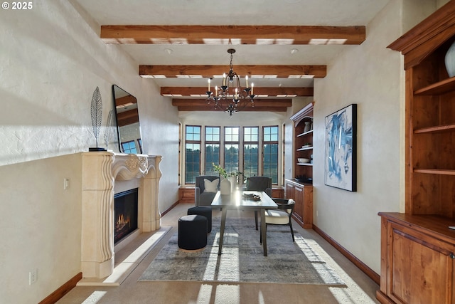 dining room with a chandelier, beam ceiling, and built in shelves