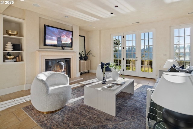 living room featuring built in features and french doors