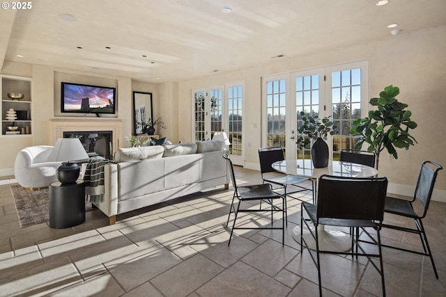 living room with french doors and built in shelves