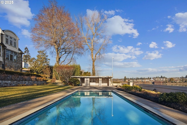 view of swimming pool with a yard and a patio area