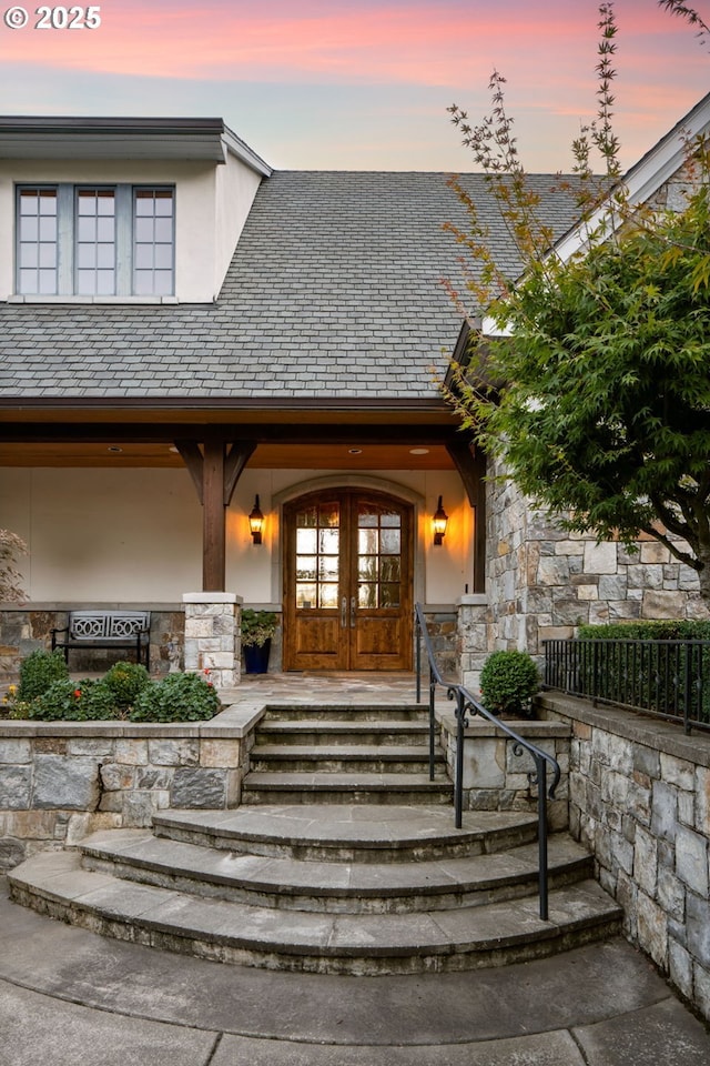 exterior entry at dusk with french doors