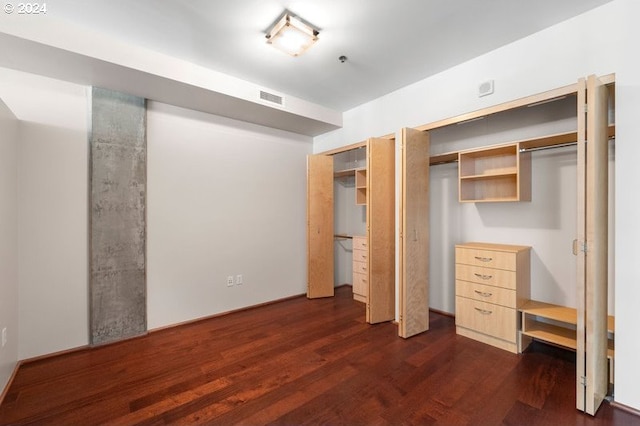 unfurnished bedroom with dark wood-type flooring