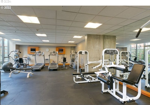 exercise room featuring a drop ceiling