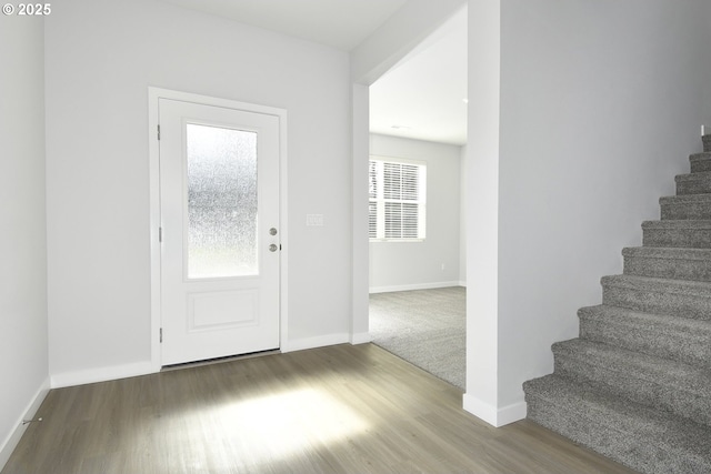 foyer entrance with plenty of natural light and wood-type flooring