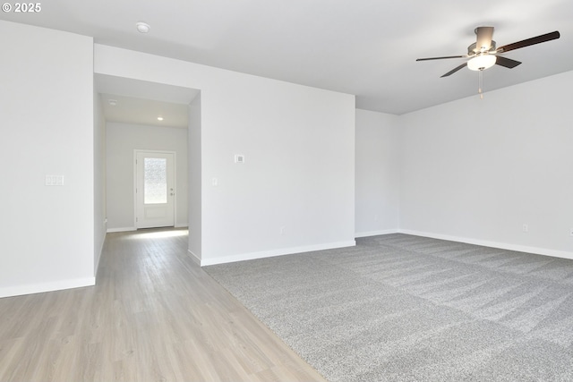 unfurnished room featuring ceiling fan and light colored carpet