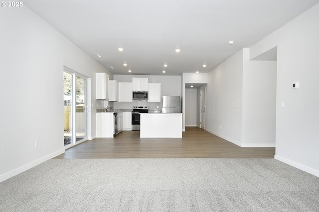 unfurnished living room with dark colored carpet