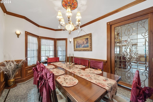 carpeted dining area with a notable chandelier and ornamental molding