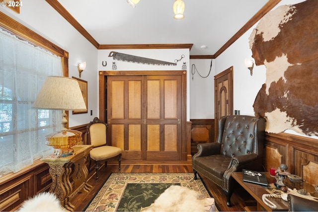 sitting room featuring crown molding and hardwood / wood-style flooring