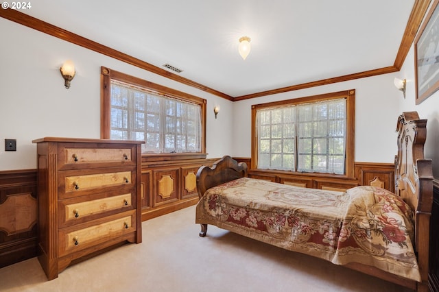 bedroom with wooden walls, light colored carpet, and crown molding