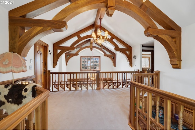 hall with beamed ceiling, a notable chandelier, high vaulted ceiling, and carpet floors