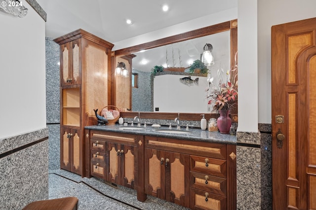 bathroom featuring vanity and tile walls