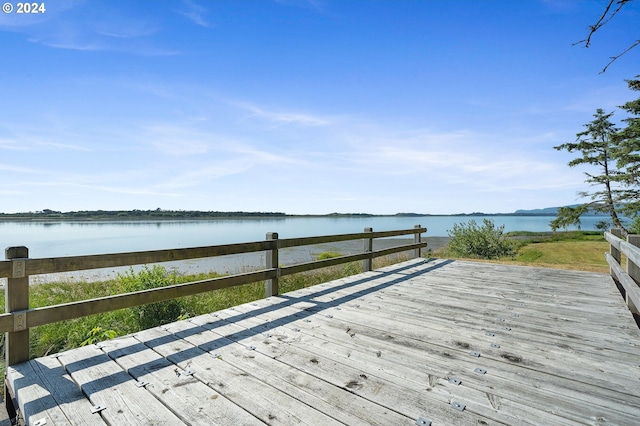 wooden deck featuring a water view