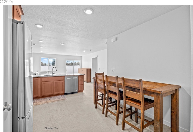 dining area with recessed lighting and a textured ceiling