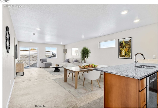 living area featuring recessed lighting, baseboards, concrete flooring, and a textured ceiling