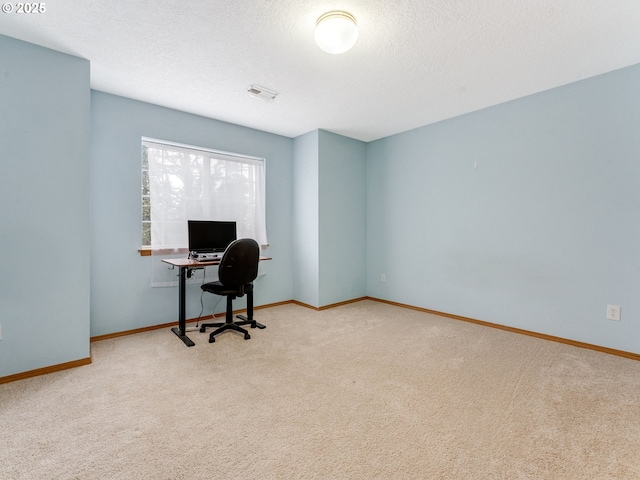 carpeted office space featuring visible vents, baseboards, and a textured ceiling