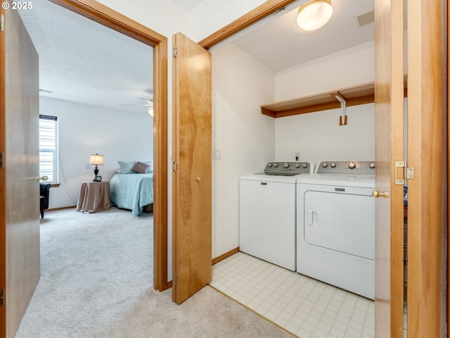 laundry area featuring visible vents, light carpet, laundry area, a ceiling fan, and separate washer and dryer