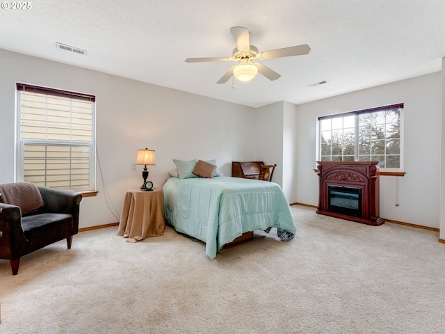 bedroom featuring visible vents, carpet, and ceiling fan