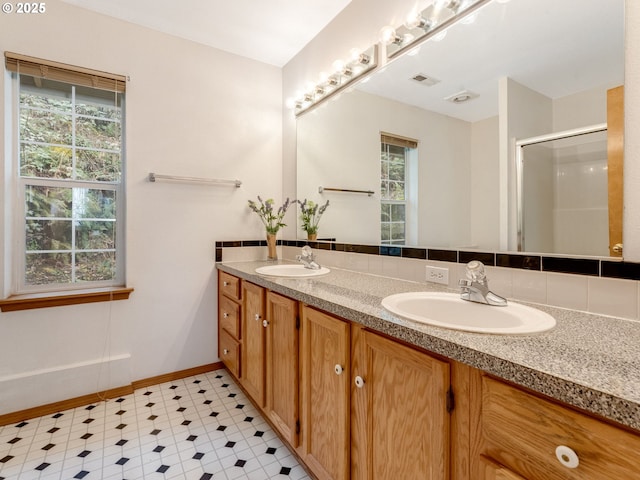 4196 SE Pinehurst Ave, Milwaukie, OR 97267 - bathroom featuring double vanity, healthy amount of natural light, a shower stall, and tile patterned floors