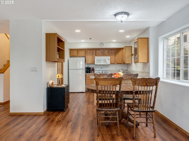 dining room with recessed lighting, baseboards, dark wood-style flooring, and a textured ceiling