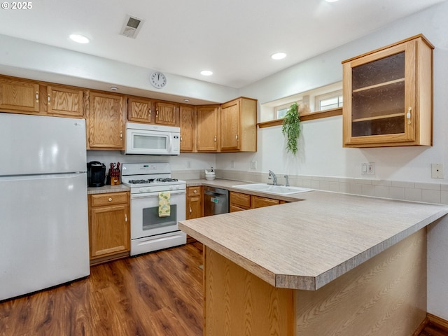 4196 SE Pinehurst Ave, Milwaukie, OR 97267 - kitchen featuring white appliances, a sink, light countertops, a peninsula, and dark wood-style floors
