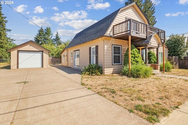 view of property with a garage and an outbuilding