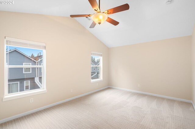 unfurnished room featuring baseboards, light colored carpet, a ceiling fan, and lofted ceiling