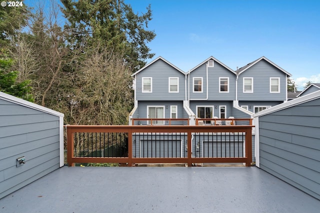 rear view of house featuring a wooden deck