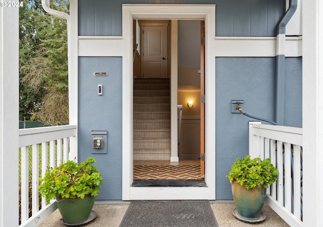 doorway to property with stucco siding