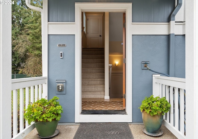 property entrance with stucco siding
