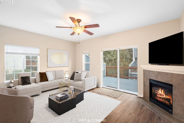 5171 SW 174th Ter, Beaverton, OR 97078 - living room with wood finished floors, a fireplace, ceiling fan, and baseboards