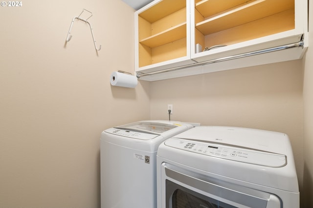 laundry area with washing machine and clothes dryer and laundry area