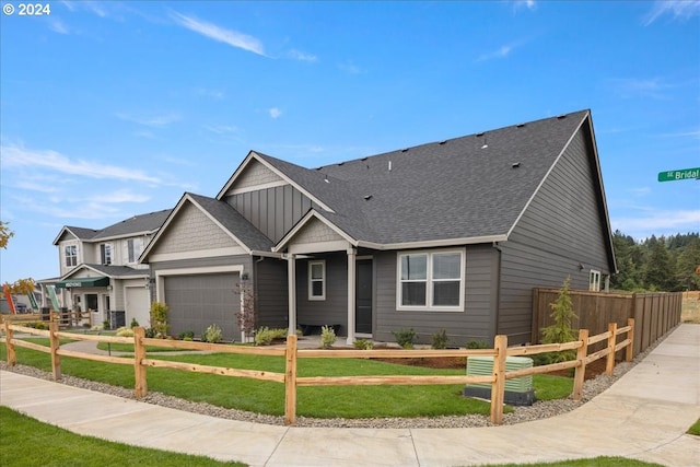 craftsman-style home featuring a garage and a front yard