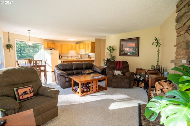 carpeted living room featuring a textured ceiling