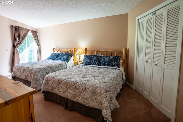 carpeted bedroom featuring a textured ceiling and a closet