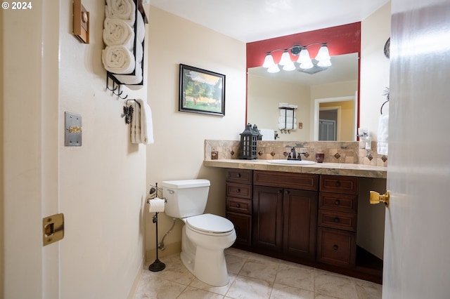 bathroom with vanity, tasteful backsplash, and toilet