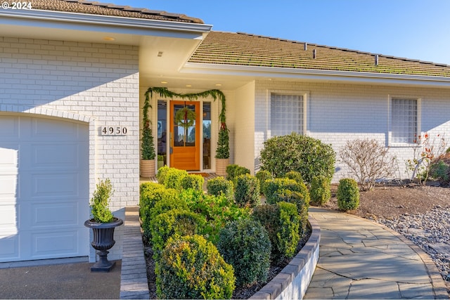 doorway to property featuring a garage