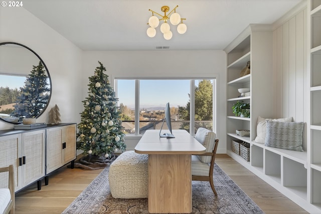 dining room featuring light hardwood / wood-style floors and an inviting chandelier