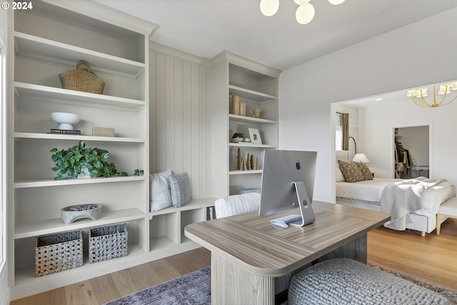 office featuring hardwood / wood-style floors and an inviting chandelier