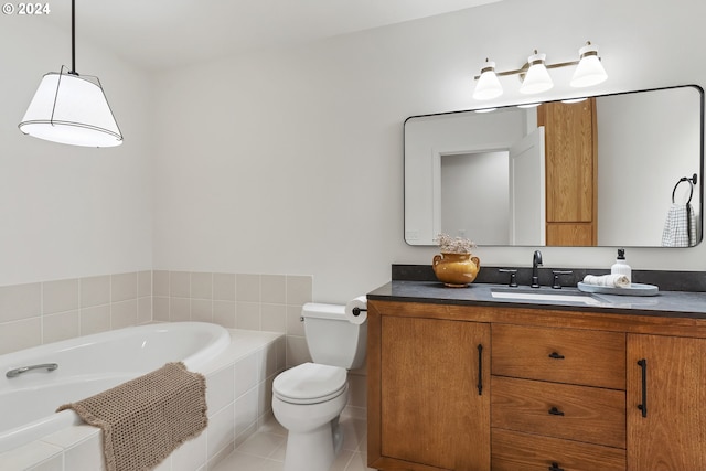 bathroom featuring tile patterned floors, vanity, a relaxing tiled tub, and toilet