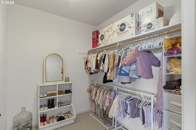 walk in closet featuring carpet