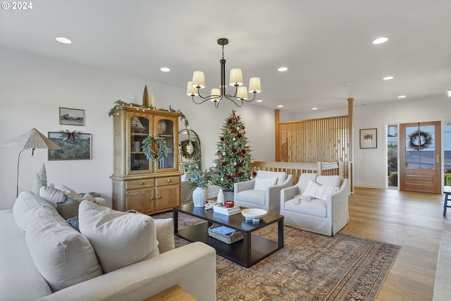 living room featuring a chandelier and light hardwood / wood-style flooring