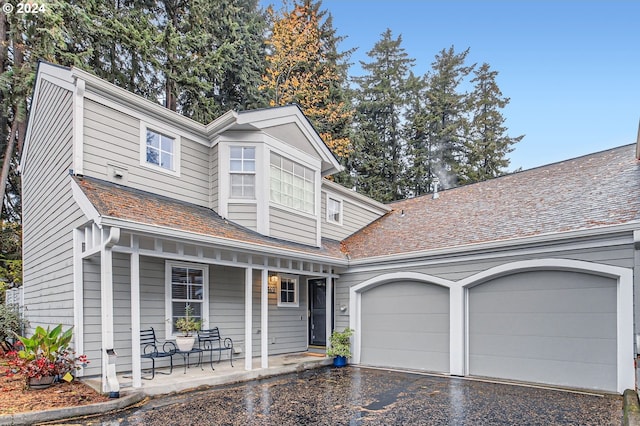 view of front of property featuring a porch and a garage