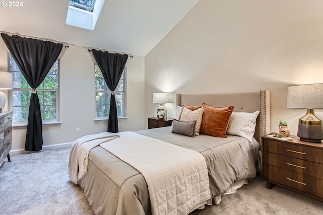 bedroom featuring light carpet and vaulted ceiling with skylight