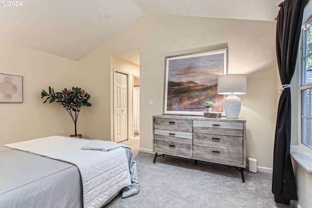 carpeted bedroom featuring vaulted ceiling