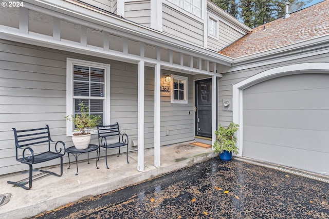 property entrance featuring a garage and covered porch