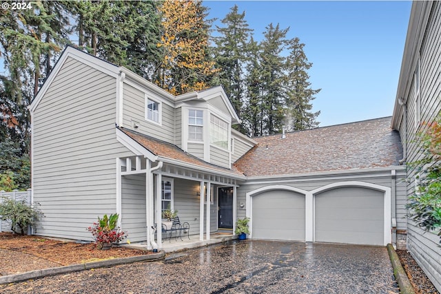 view of front property featuring a garage and covered porch