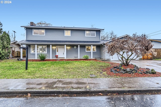 view of property with covered porch and a front yard