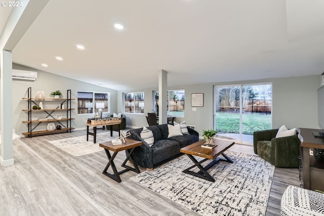 living room featuring a wall mounted air conditioner, light wood-type flooring, and lofted ceiling