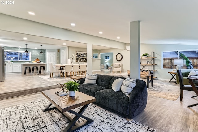 living room featuring lofted ceiling and light hardwood / wood-style flooring